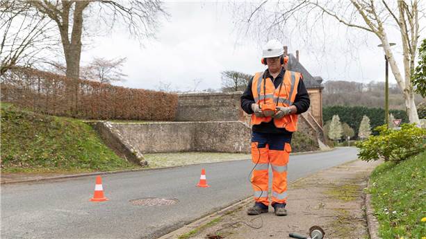 SUEZ employee searching for a water leak using a portable camera